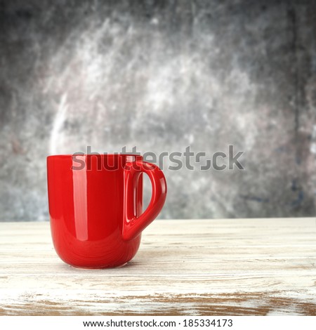 gray wall and white desk and red mug