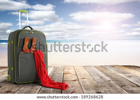 summer sun and suitcase with red decoration of towel