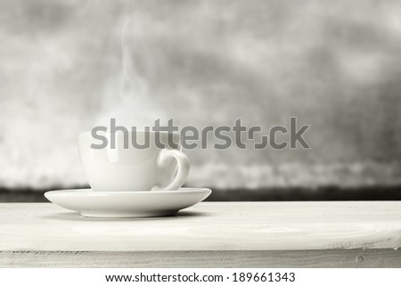 white mug and coffee on white sill