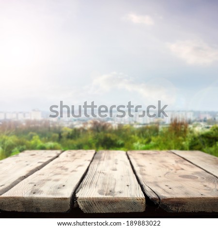 green space city landscape and wooden table