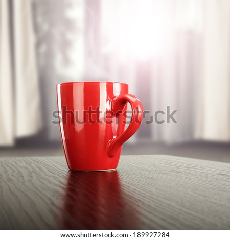 warm red mug and window