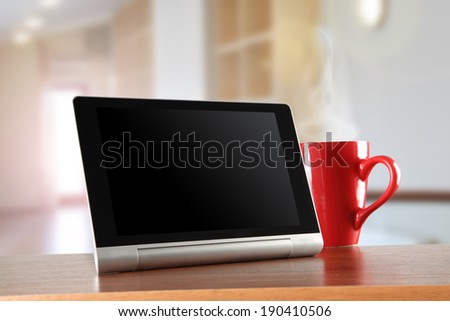 tablet office and red mug