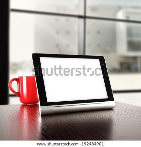 dark brown desk and window with tablet