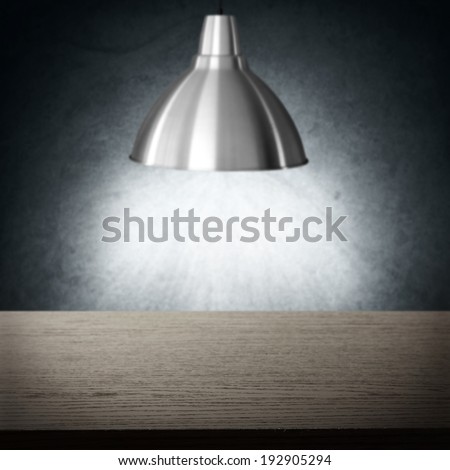 dark desk and light of lamp in interior