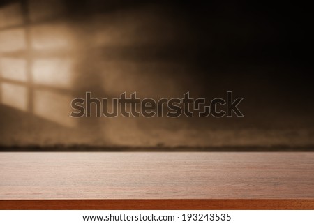 dark wall with shadow of window and wooden sill with free space