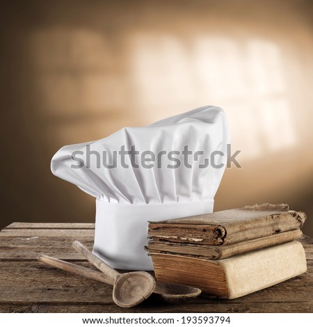 books in kitchen and cook hat with shadows of window