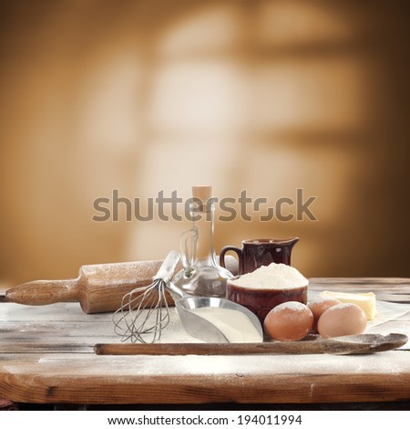 decoration of flour oil eggs milk spoon and window shadow