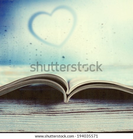 small book and heart space on glass
