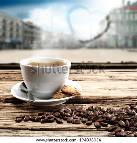 cup of coffee in cafe with background of city and heart on glass