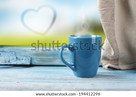 wet glass and blue mug with love