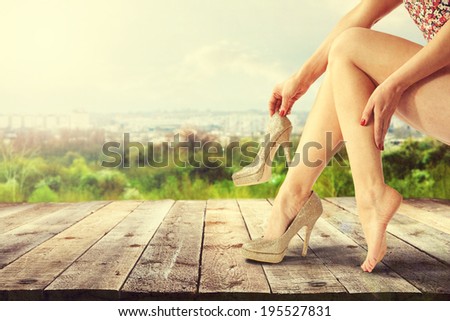 photo of legs and wooden deck