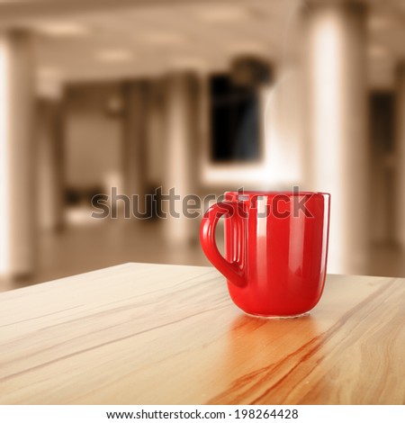 yellow desk and red mug in interior space