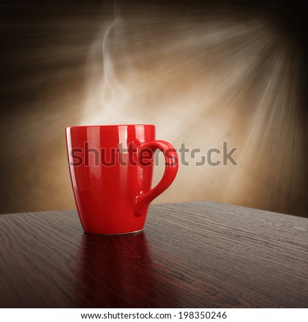 dark desk and dark red mug