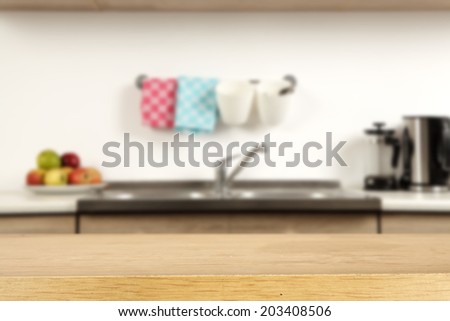 empty wooden desk of yellow and kitchen space