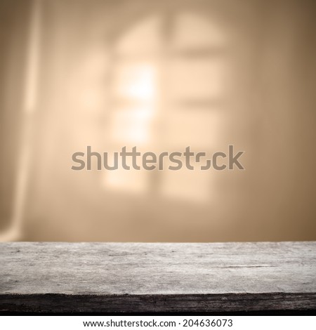 gray desk of worn wood and window shadow space