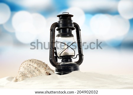 shells oil lamp and sea background