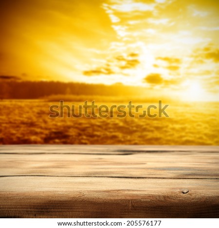 sky with sun with sunset time and desk of retro wood space