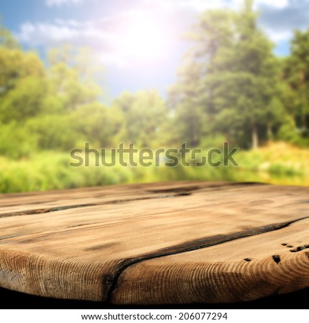river sunset in landscape and worn table