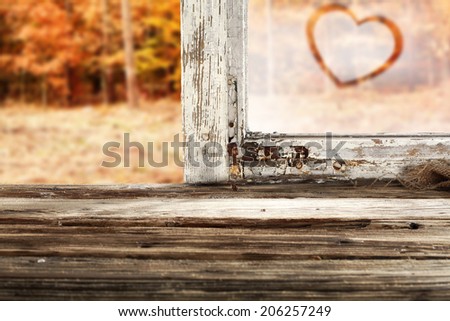 window sill and heart of love on glass and autumn background space