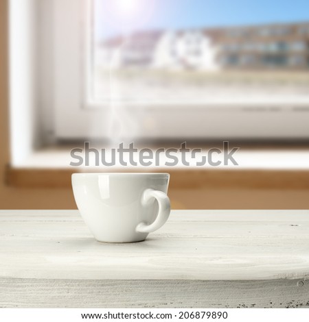 cup white desk and window space