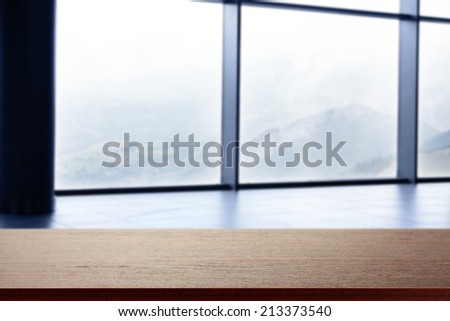 dark brown desk and window space with glass