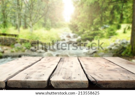 worn table of wood and forest with river
