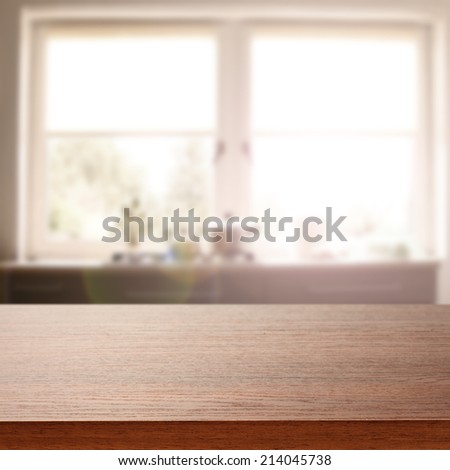 brown desk and window space and free space in kitchen
