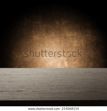 dark black desk and wall of brown color with shadow