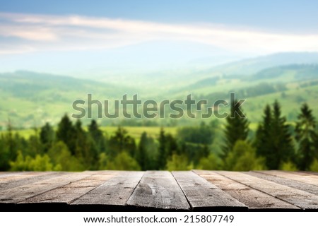 wooden terrace and mountains of green color