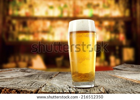 glass of golden beer in restaurant or bar