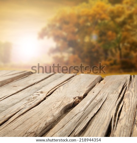 autumn background and worn wooden table