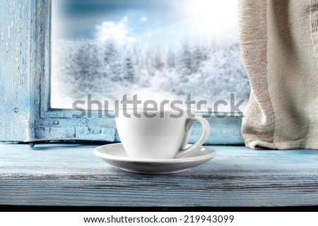 white mug and window of blue