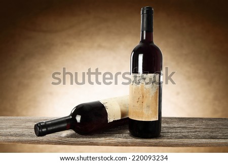 bottles of wine and brown wall with shadow