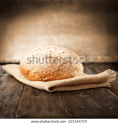 fresh brown bread on brown old table
