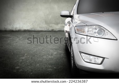 silver car without a trade brand in dark garage