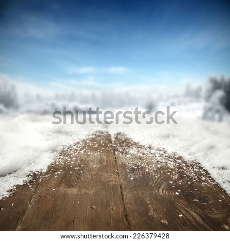 landscape of snow and blue sky and wooden table of snow