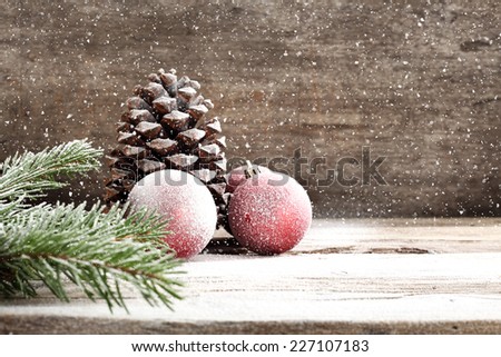 holiday decoration on wooden sill and decoration of red balls and cone and tree