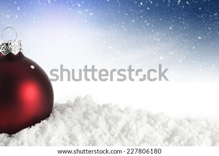 decoration of red holiday ball and snow with space for text