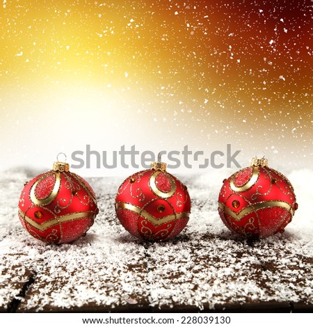 holiday background with white snowflakes and red balls and desk
