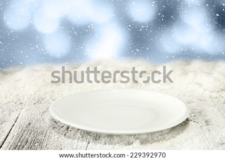 single empty plate and snow