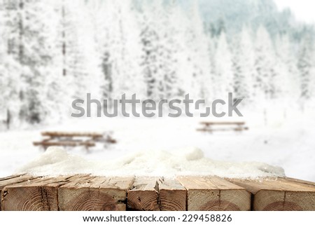 winter landscape of snow and forest with wooden background of free space