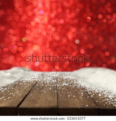 worn old table of snow with red wall of lights
