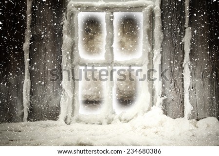 dark window and snow on wooden sill