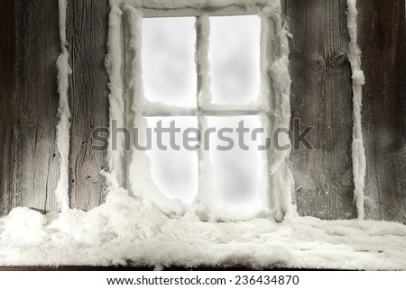 retro frame of window and white snow and frost on glass