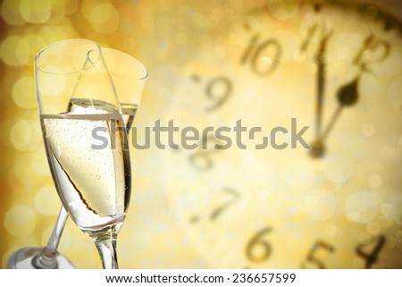 glasses of golden drink and time of new year
