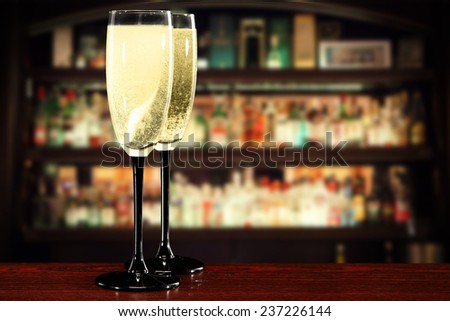 glasses of champagne and dark interior of bar in new year time