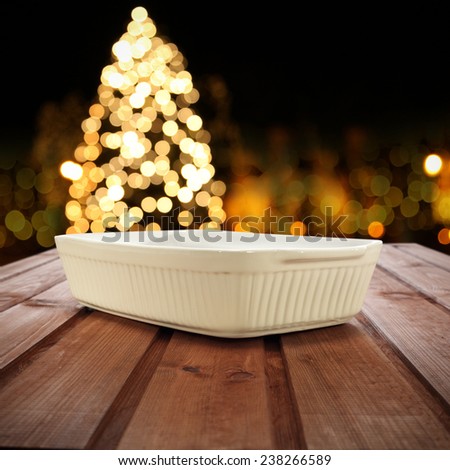 wooden table plate and xmas tree in night