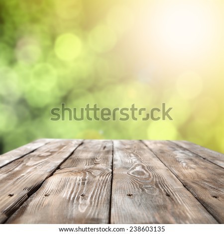 wooden table and free space for you and bokeh space of green and yellow
