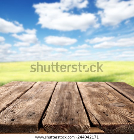 spring background of meadow sky and brown table place