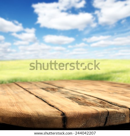 spring background of meadow sky and dark old table place